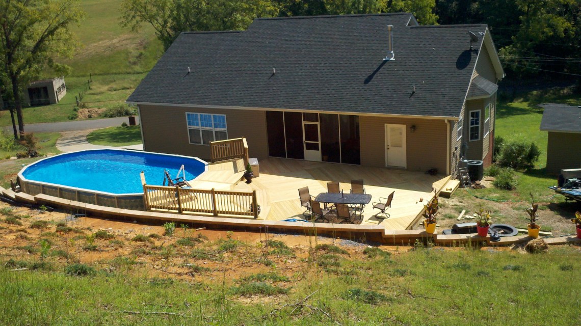 deck around a pool with custom patterns and multiple levels