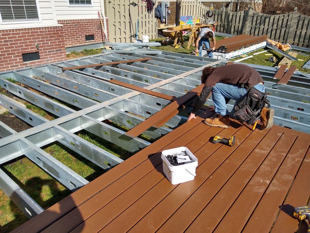 Deck builder installing trex decking