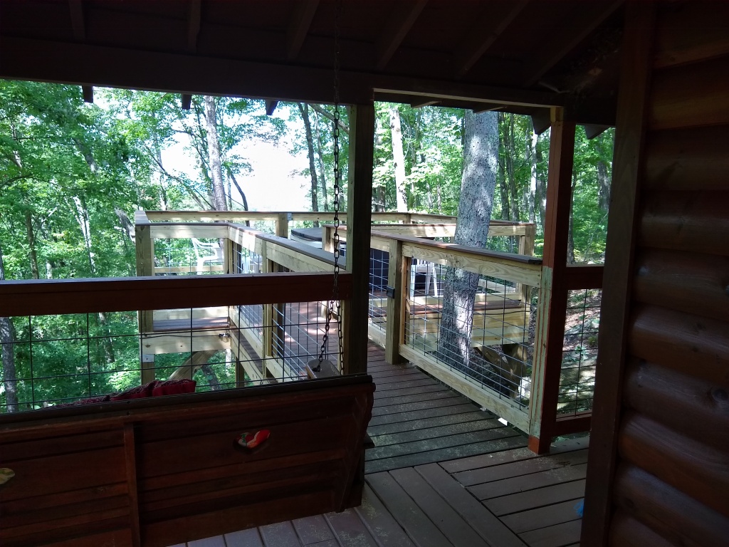 View of the back deck with hogwire railing and a hot tub on the deck