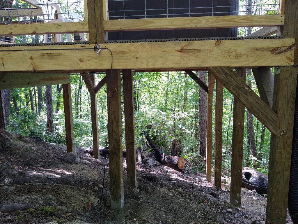 Support post underneath the deck supporting the hot tub